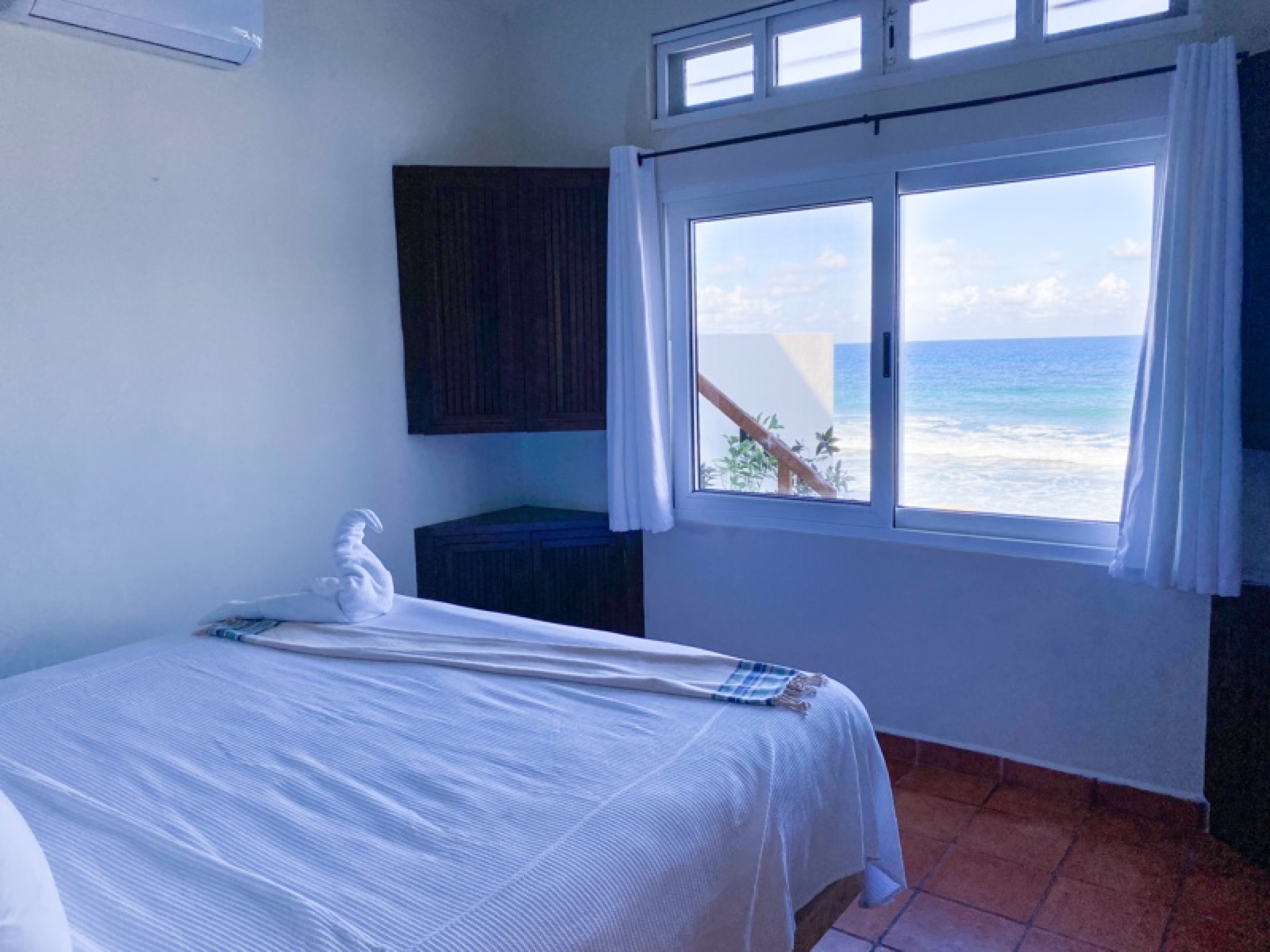 Bedroom with ocean view window — Rincón del Descanso Isla Mujeres