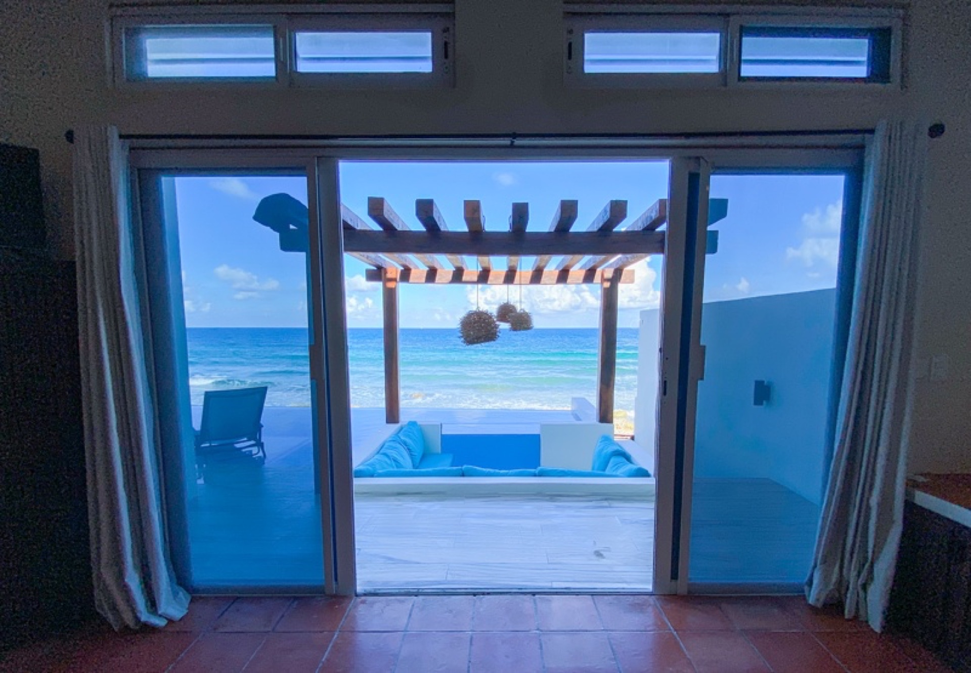Interior looking through sliding doors to the pool pergola Isla Mujeres