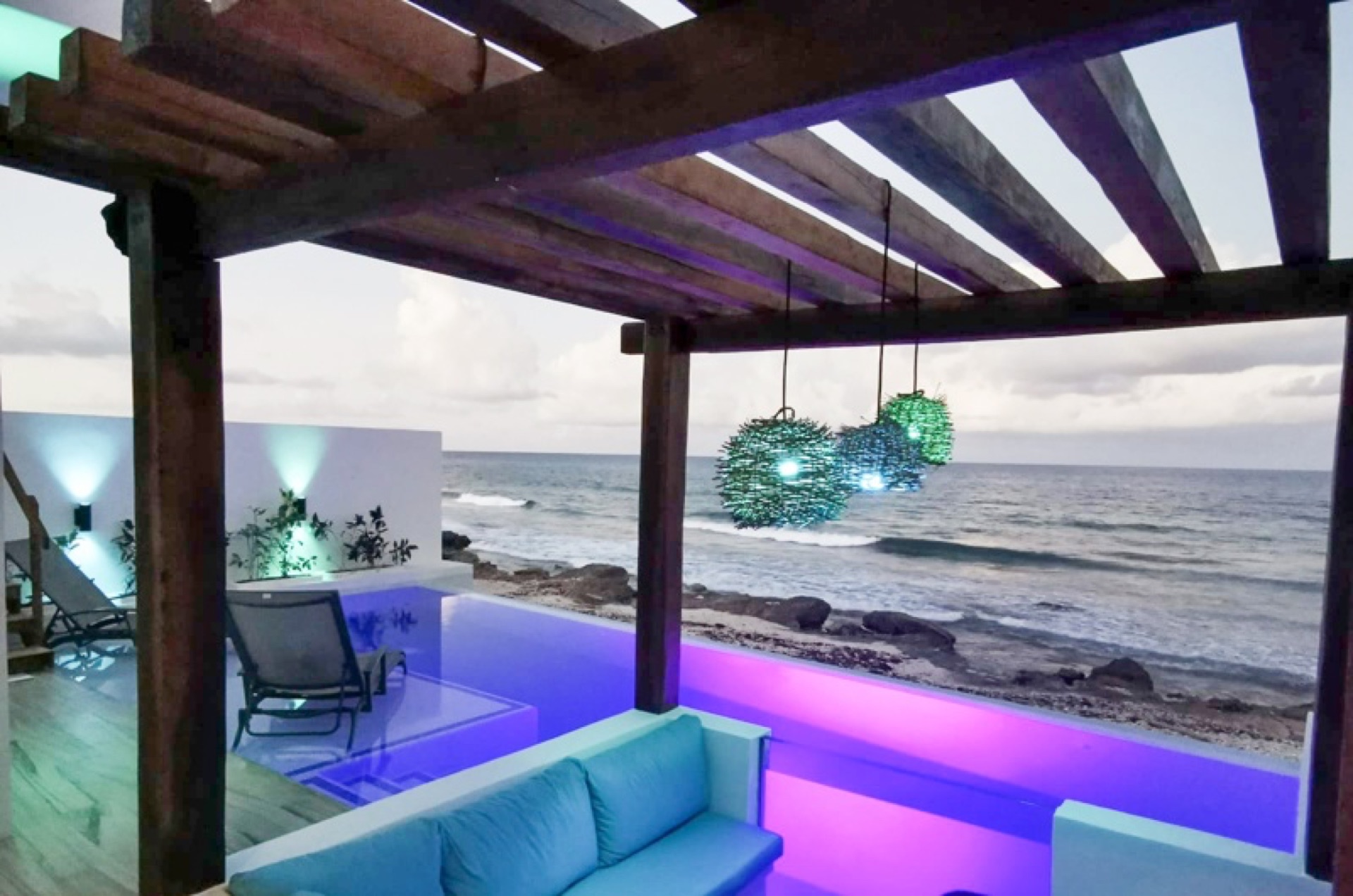 Rooftop pergola with evening lighting — oceanfront vacation rental Isla Mujeres