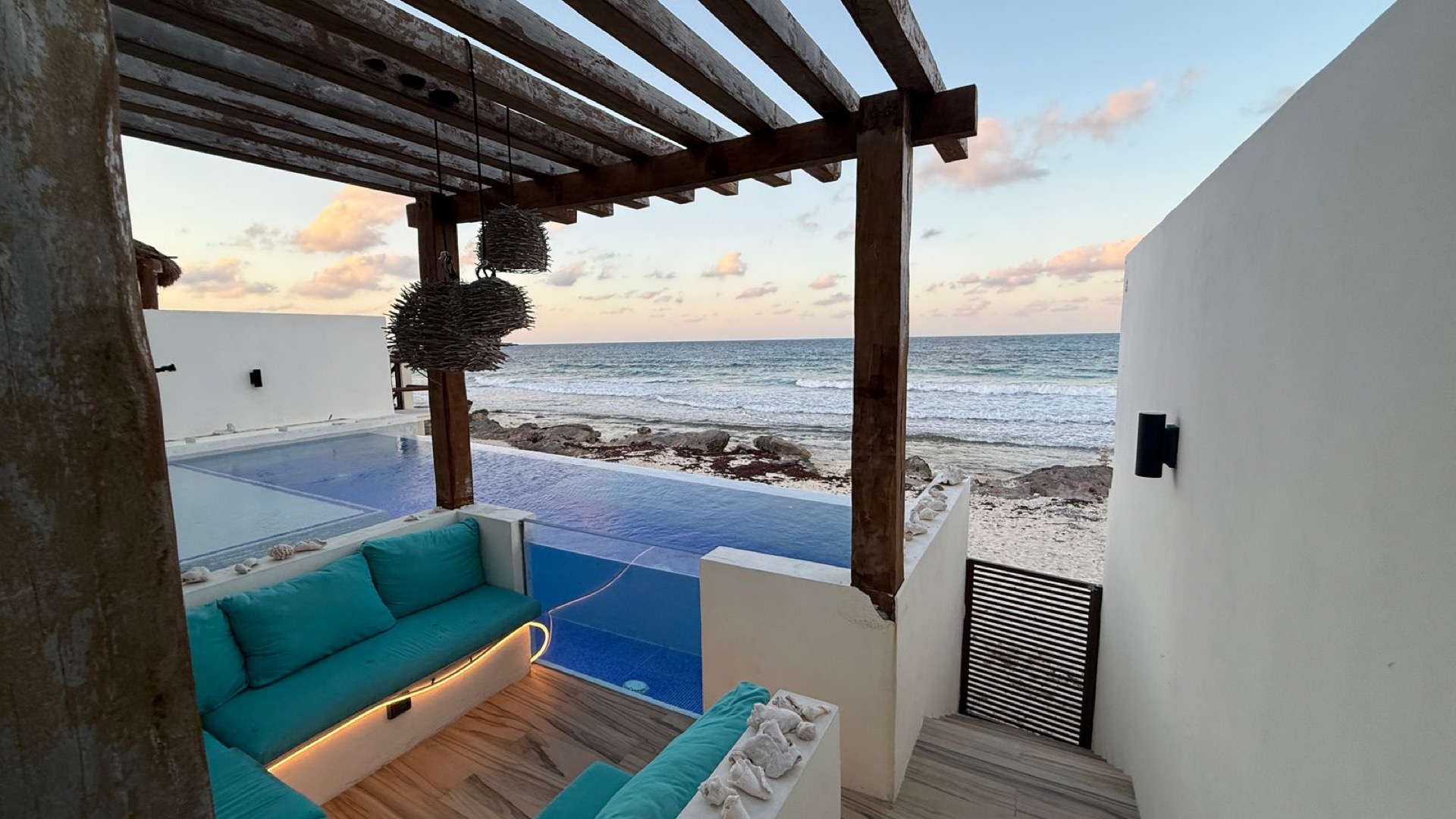 Caribbean ocean view through the poolside pergola at Rincón del Descanso