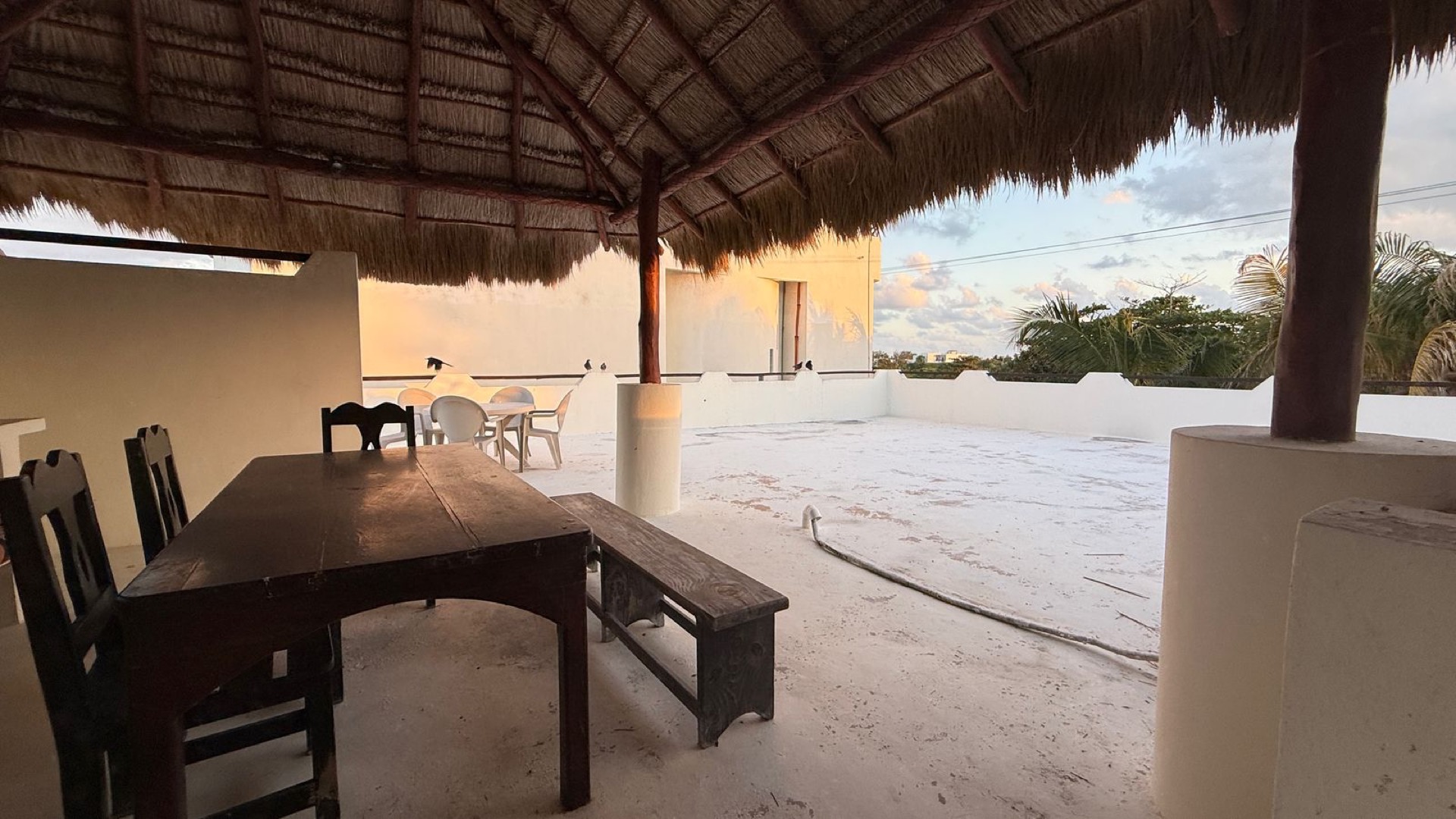 Palapa-covered dining area on the rooftop of beachfront house Isla Mujeres