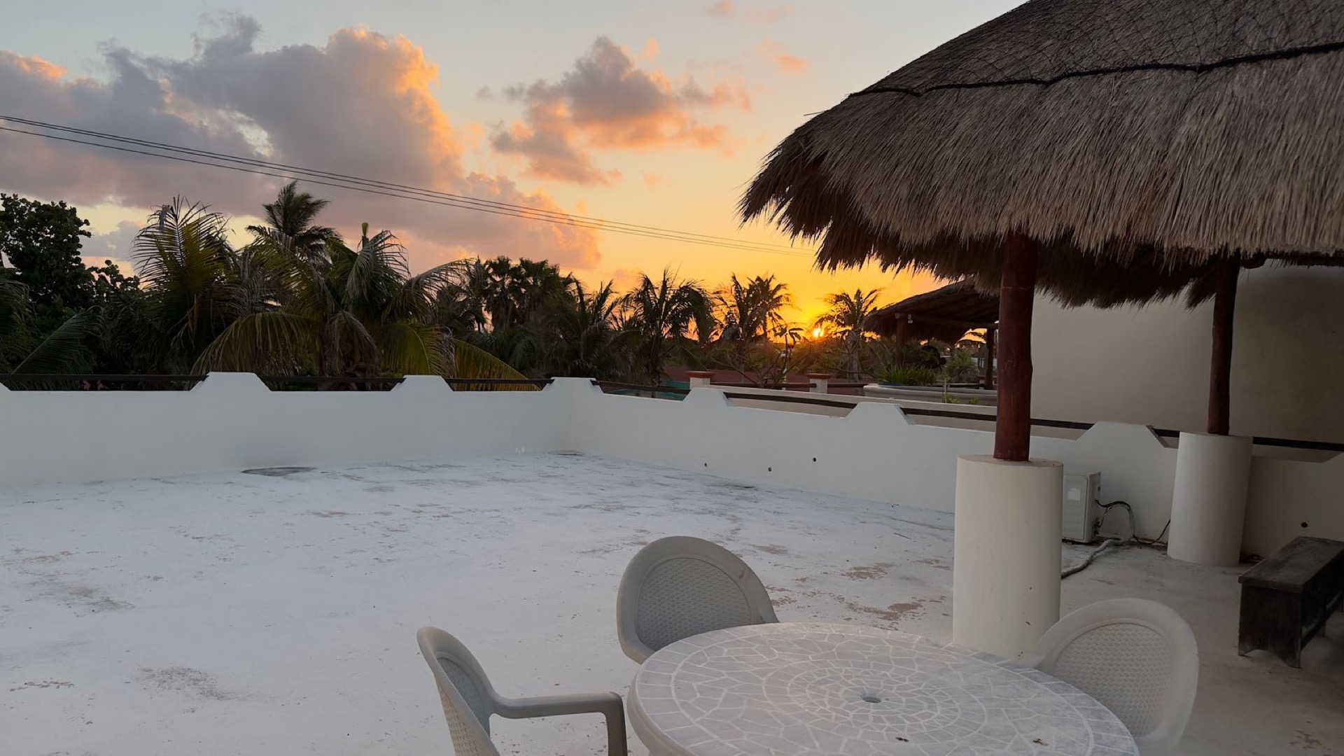 Rooftop palapa dining at sunset overlooking Cancún Bay