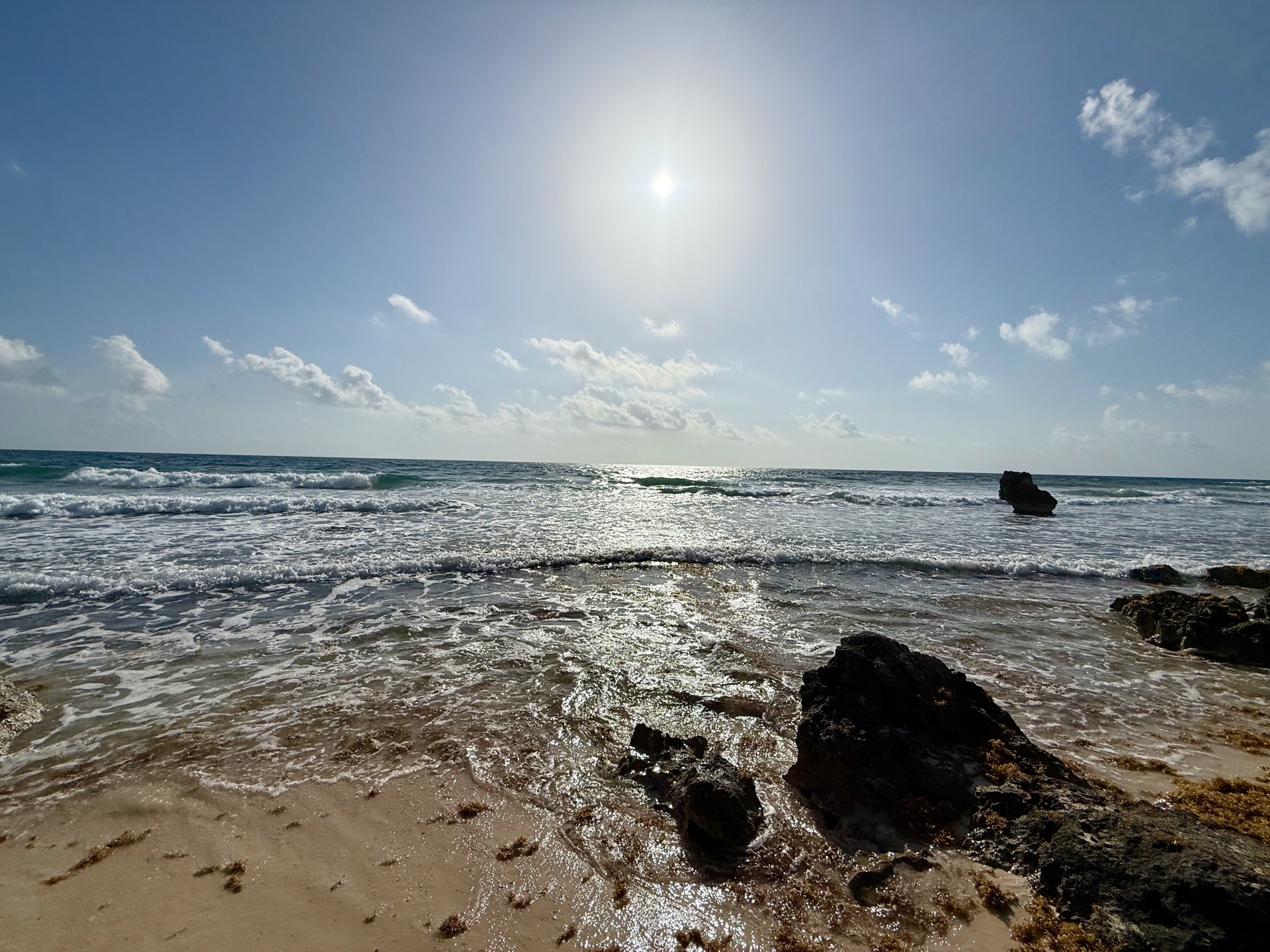 Waves breaking over the rocks on the beach Isla Mujeres