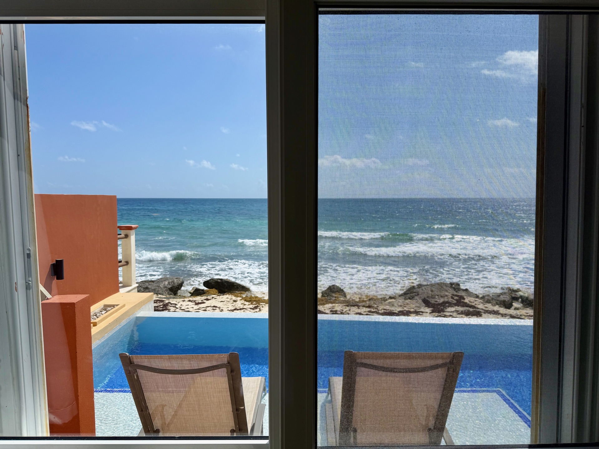 Bedroom sliding door view of the infinity pool and ocean Isla Mujeres rental