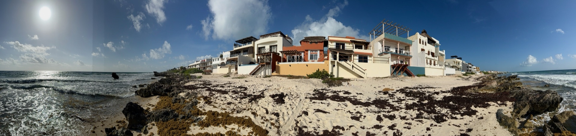 Wide view of the beachfront row of homes including Rincón del Descanso Isla Mujeres