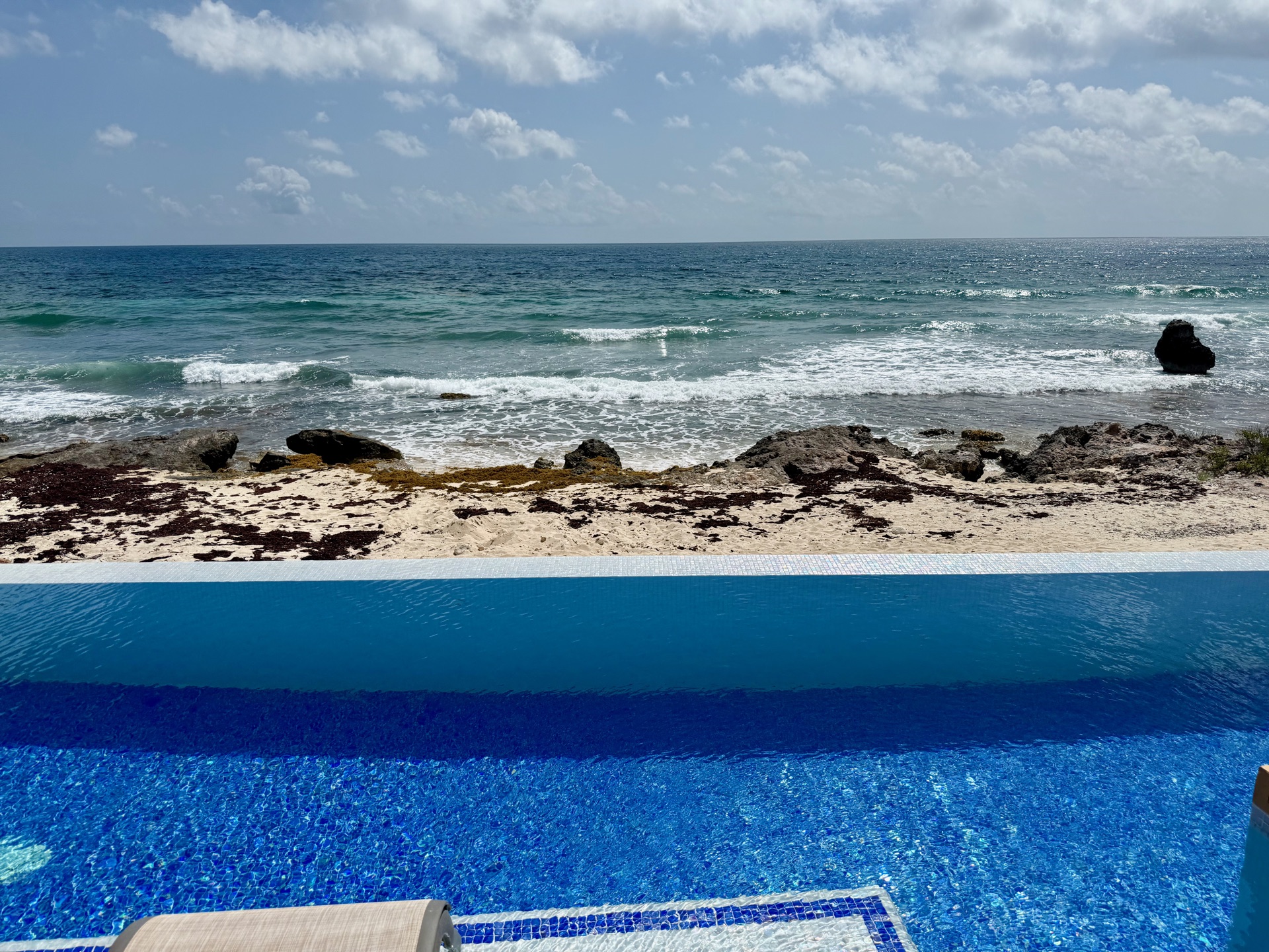Wide view of the infinity pool and pergola in the afternoon Isla Mujeres