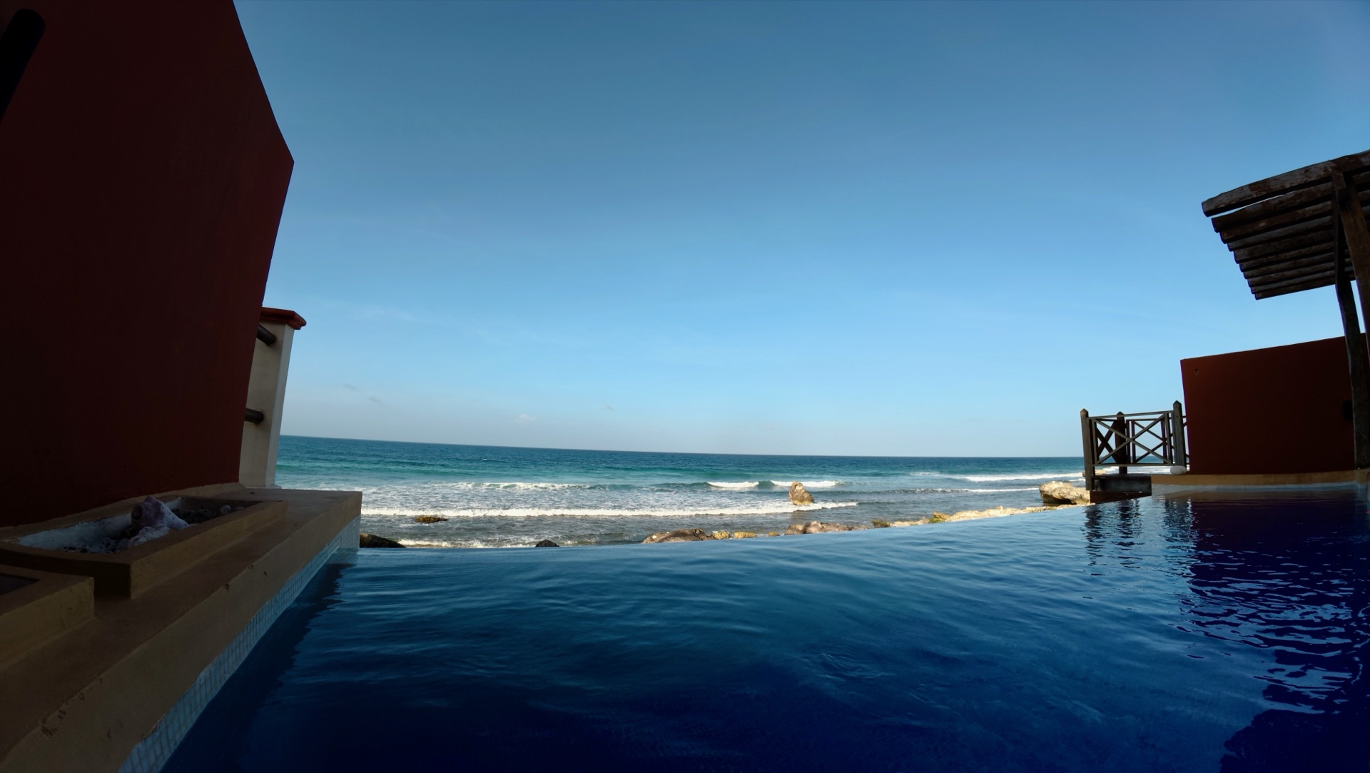 Evening view of the house and pool terrace from water level — Rincón del Descanso Isla Mujeres
